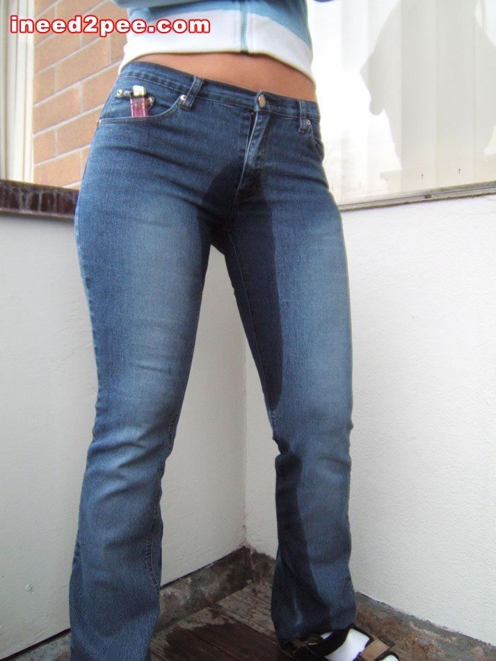 Girl wetting tight blue jeans